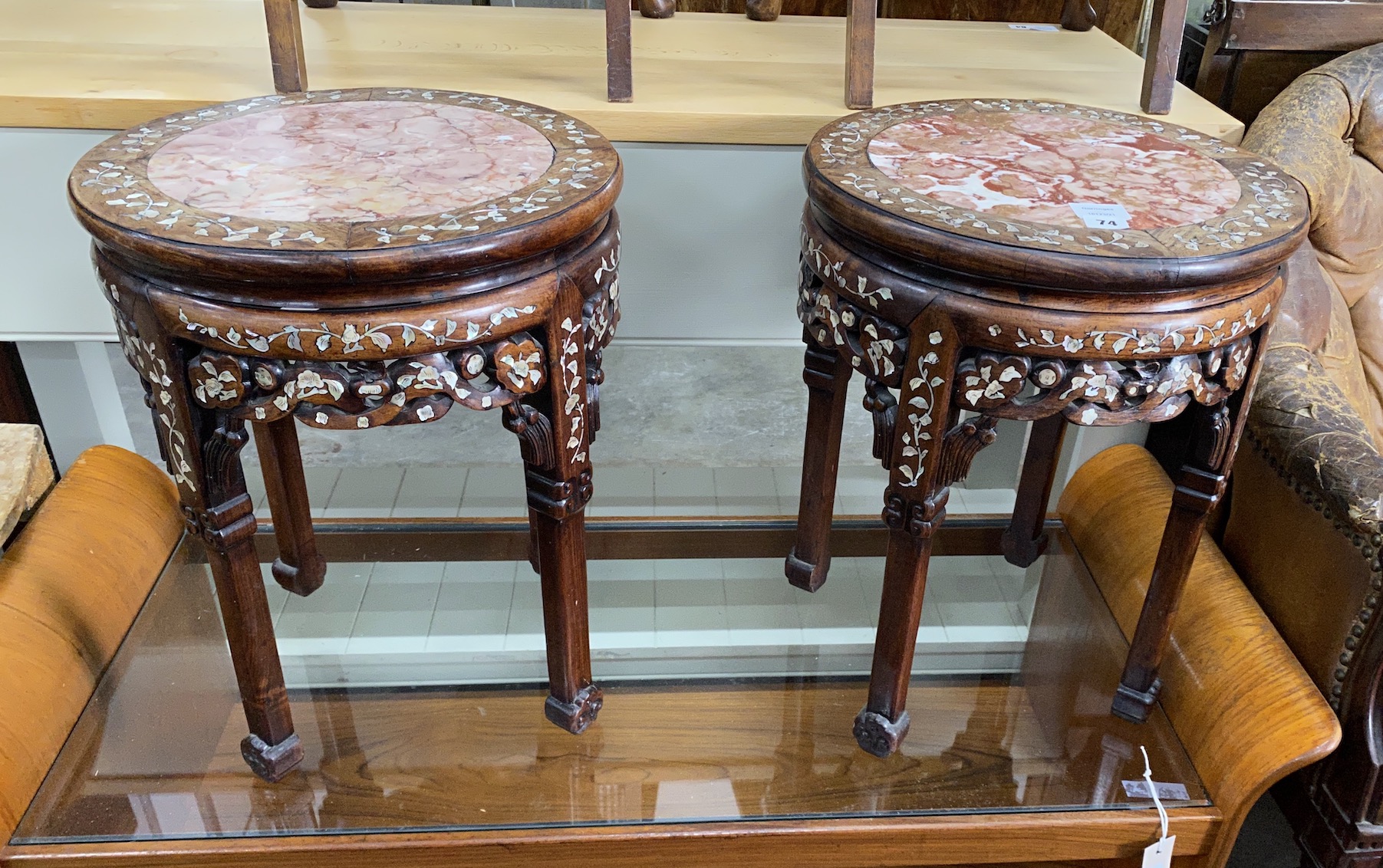 A pair of Chinese circular rouge marble topped mother of pearl inlaid hardwood jardiniere stands, diameter 40cm, height 51cm